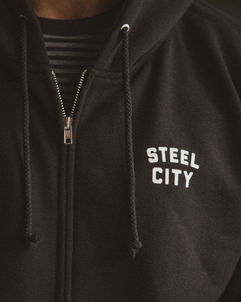 Detail of White Steel City Logo on Black Unisex Zip Hoodie