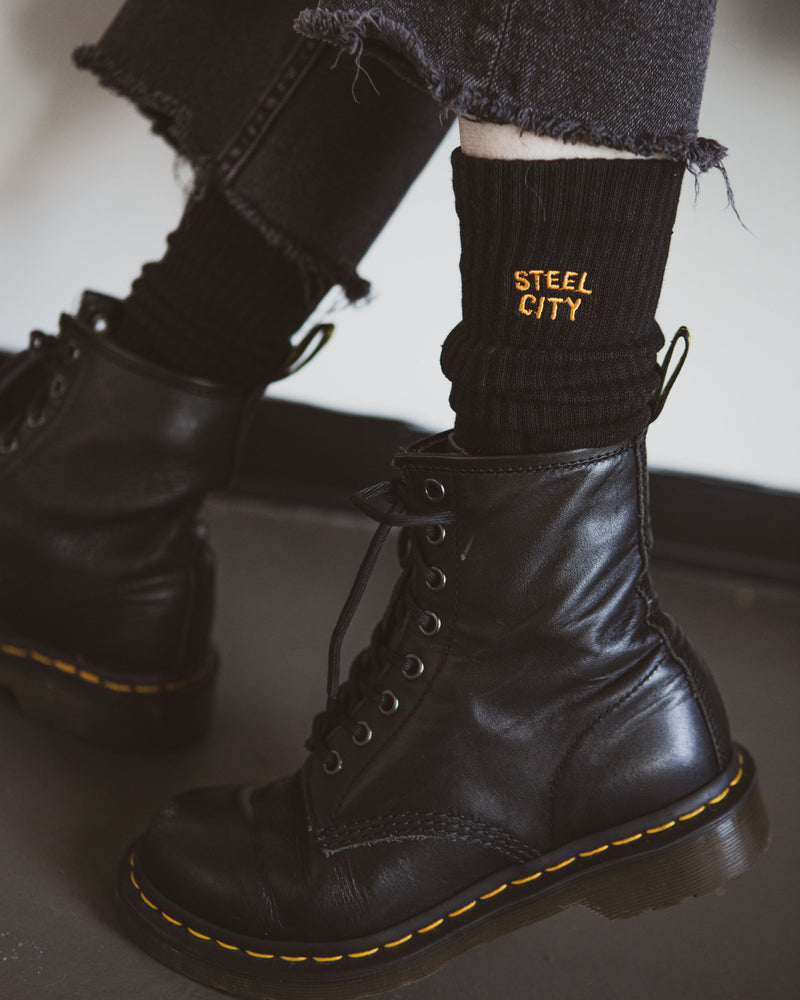Gold Steel City on Black Sock With Boot